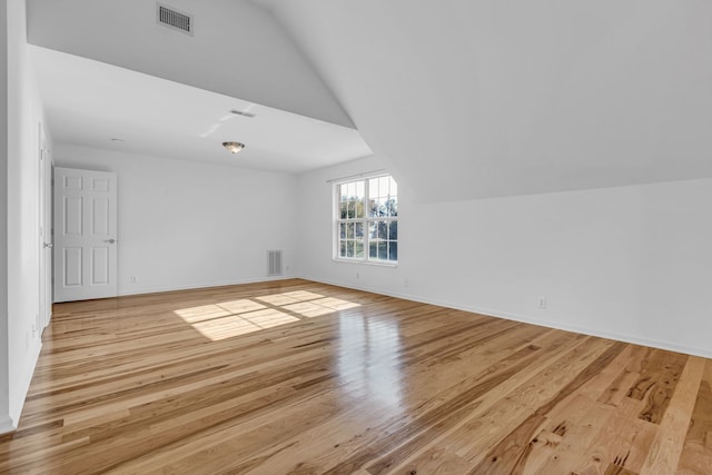 bonus room with light hardwood / wood-style flooring and vaulted ceiling