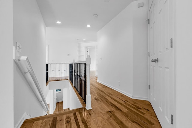 staircase with hardwood / wood-style flooring