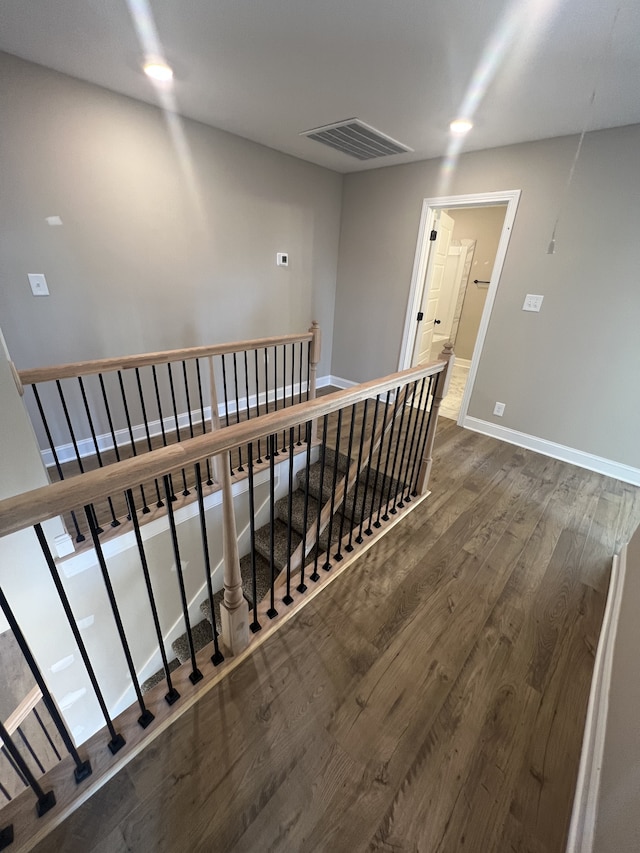 stairway featuring wood-type flooring