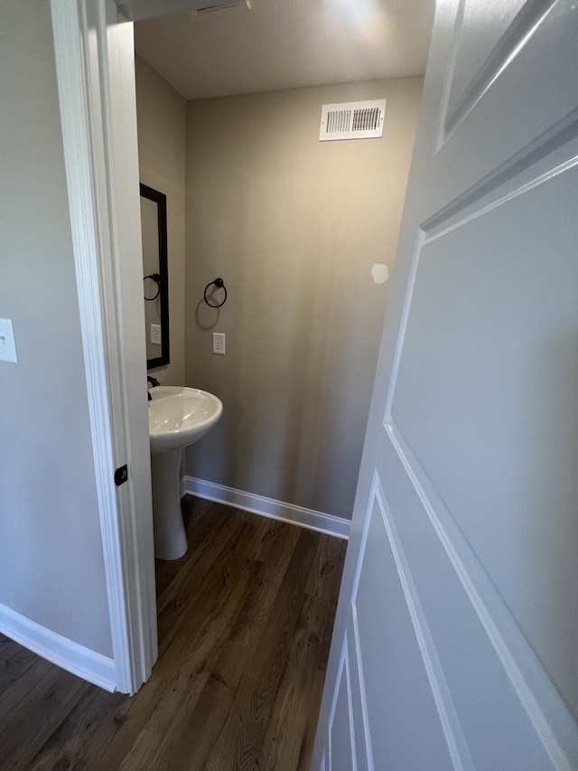 bathroom with hardwood / wood-style floors