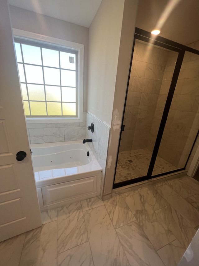 bathroom featuring shower with separate bathtub