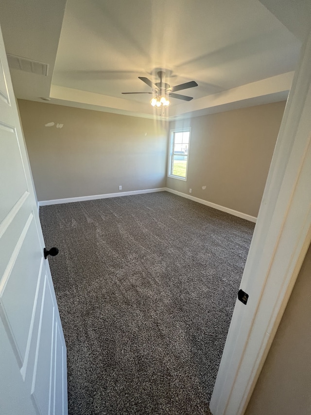 carpeted spare room with ceiling fan