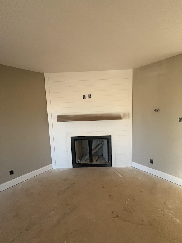 unfurnished living room with a large fireplace