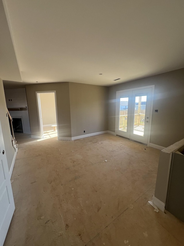 unfurnished living room with french doors