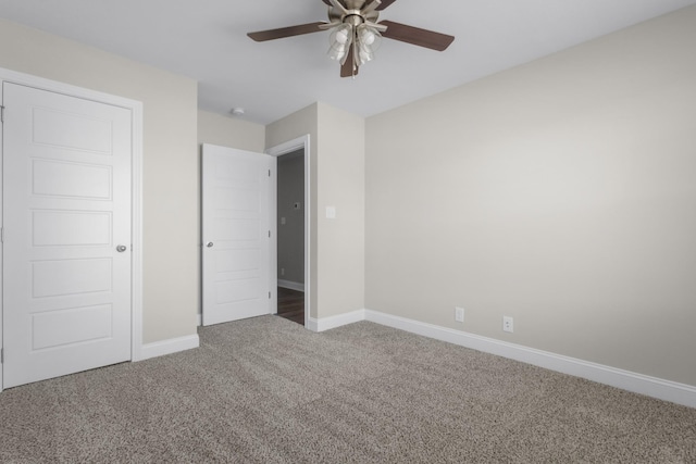 unfurnished bedroom with a ceiling fan, carpet flooring, and baseboards