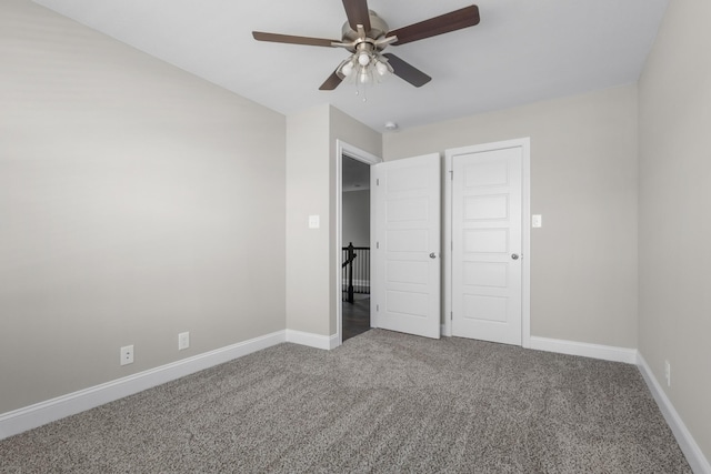 unfurnished bedroom featuring carpet flooring, ceiling fan, and baseboards