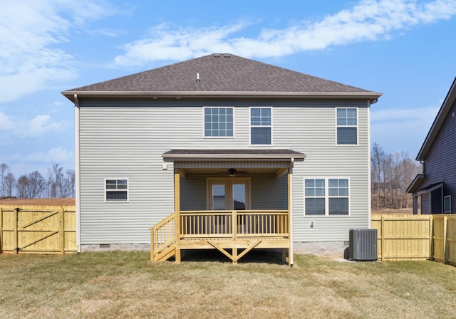 back of property with crawl space, fence, a lawn, and central air condition unit