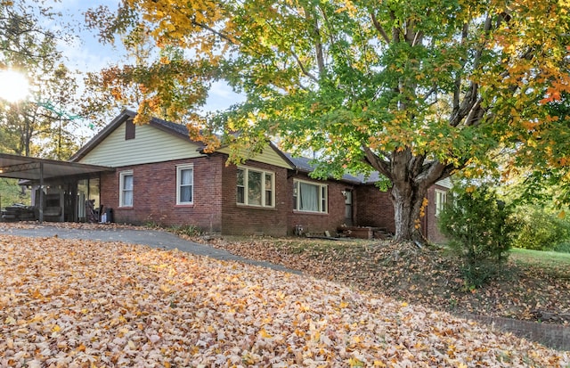 view of side of home featuring a sunroom