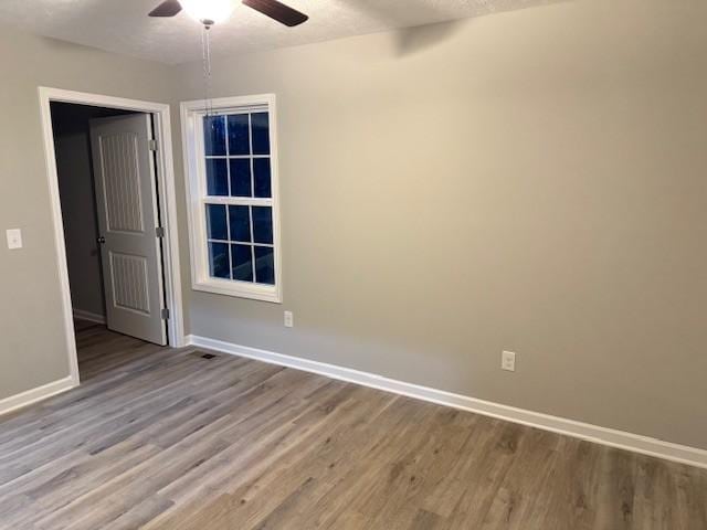 spare room with light hardwood / wood-style floors and ceiling fan