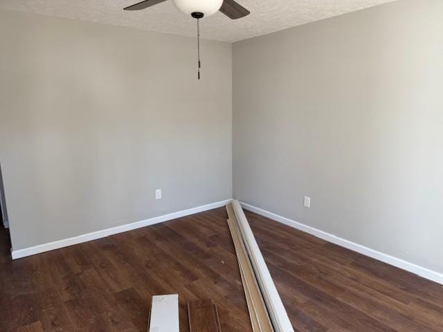 spare room with a textured ceiling, dark hardwood / wood-style floors, and ceiling fan