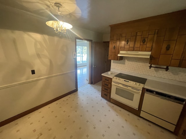 kitchen with a notable chandelier, decorative light fixtures, and white appliances