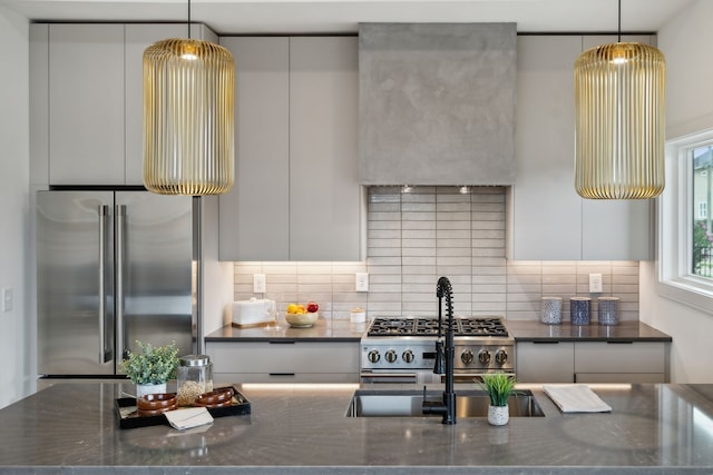 kitchen featuring white cabinetry, backsplash, appliances with stainless steel finishes, and decorative light fixtures