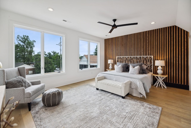 bedroom featuring ceiling fan, vaulted ceiling, and light wood-type flooring