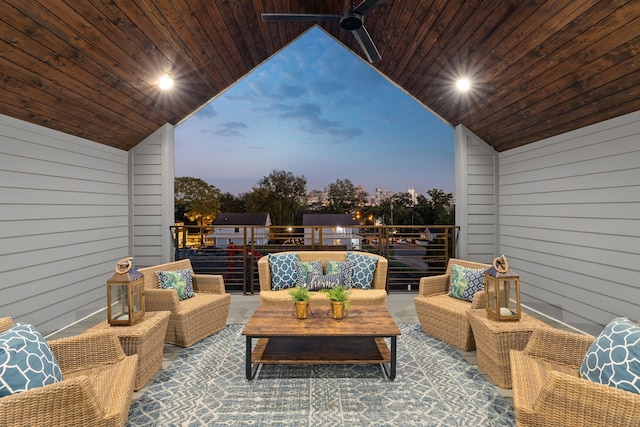 patio terrace at dusk featuring ceiling fan and outdoor lounge area