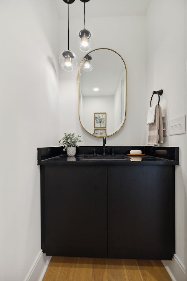 bathroom with wood-type flooring and sink