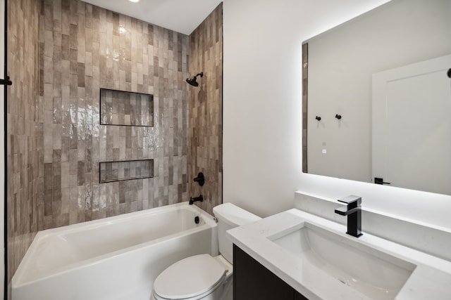 full bathroom with vanity, toilet, and tiled shower / bath