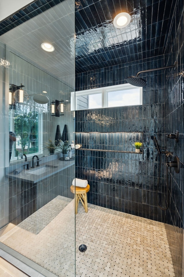 bathroom featuring tile walls and a tile shower