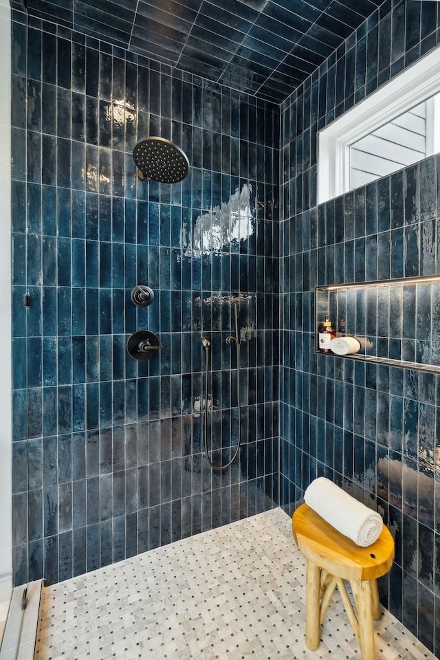 bathroom featuring tile walls and tiled shower