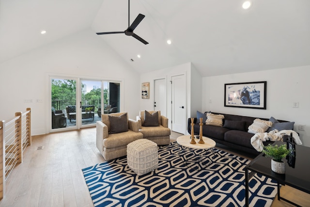 living room featuring light hardwood / wood-style floors, high vaulted ceiling, and ceiling fan