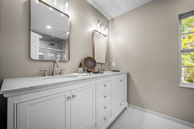 bathroom featuring a shower with shower door and vanity