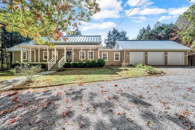 single story home with covered porch and a garage