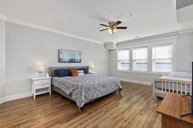 bedroom featuring ceiling fan, hardwood / wood-style flooring, and crown molding