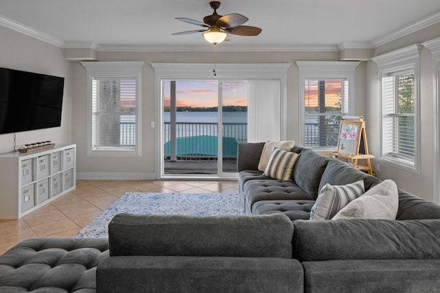 living room featuring crown molding, baseboards, a ceiling fan, and light tile patterned flooring