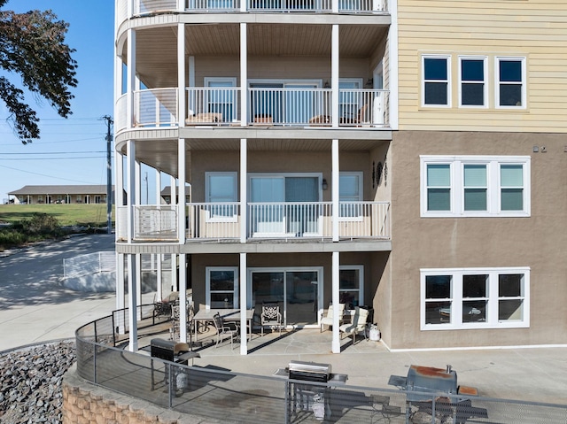 5590 Bay Village Dr Unit 1B, Athens, AL 35611 - rear view of house featuring a balcony, stucco siding, and a patio area