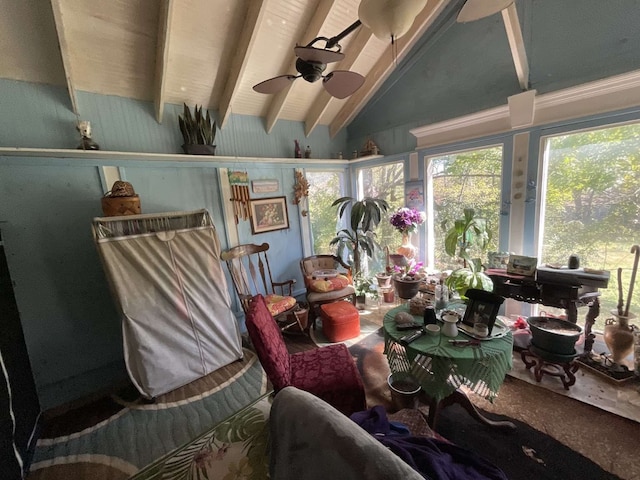 sunroom / solarium with a wealth of natural light, vaulted ceiling with beams, and ceiling fan