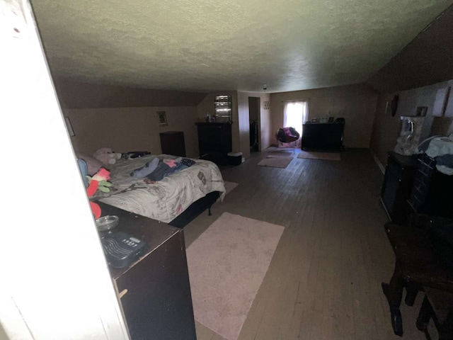 bedroom featuring hardwood / wood-style floors and a textured ceiling