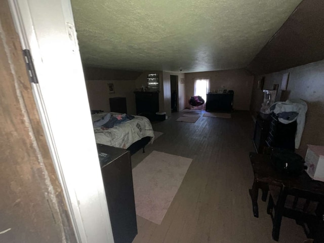 bedroom featuring a textured ceiling and hardwood / wood-style flooring