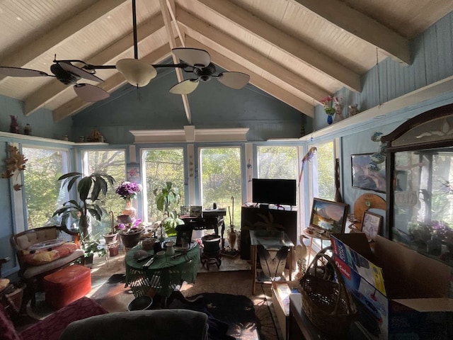 sunroom / solarium with ceiling fan and vaulted ceiling with beams