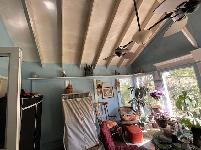 interior space featuring lofted ceiling with beams and ceiling fan