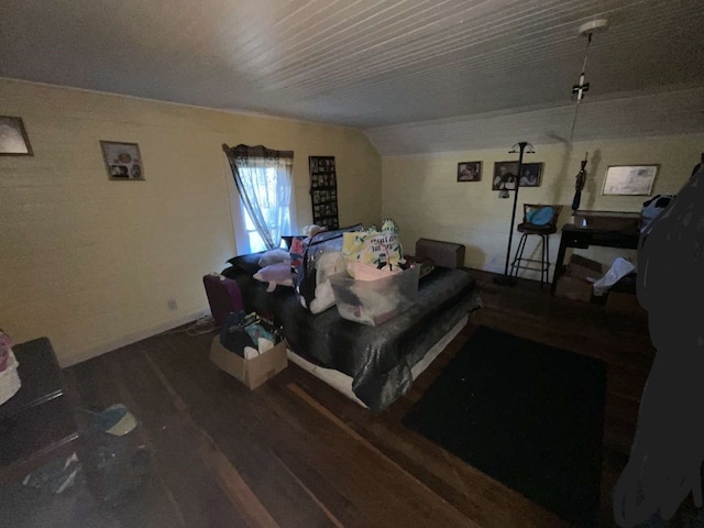 bedroom featuring vaulted ceiling and hardwood / wood-style flooring