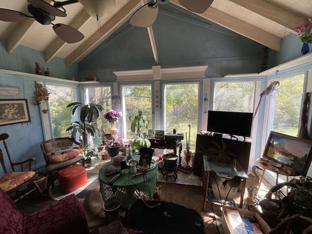 sunroom with ceiling fan and vaulted ceiling with beams