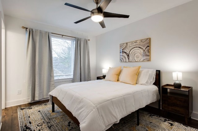 bedroom with ceiling fan and dark hardwood / wood-style flooring