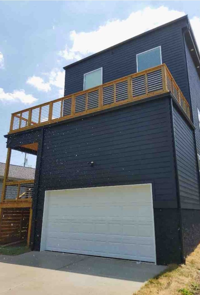 view of property exterior with a garage and a balcony