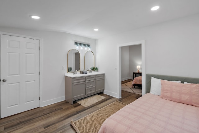 bedroom with sink and dark hardwood / wood-style flooring