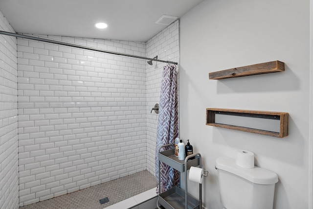 bathroom with toilet and a shower with curtain