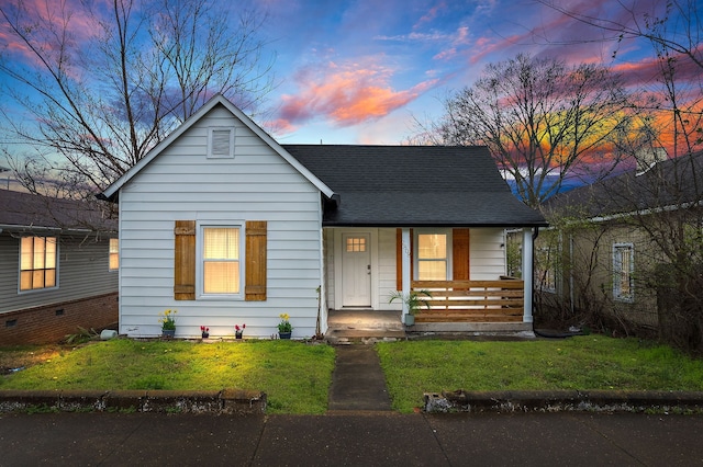 bungalow-style home with a yard and a porch