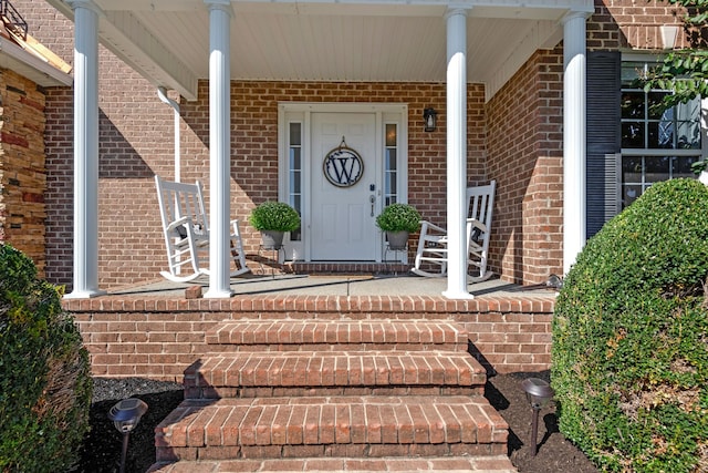 doorway to property featuring covered porch