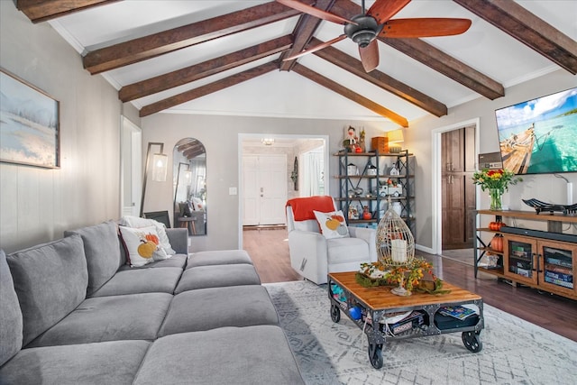 living room with ceiling fan, vaulted ceiling with beams, and hardwood / wood-style floors