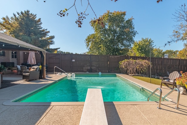 view of pool featuring a patio and a diving board