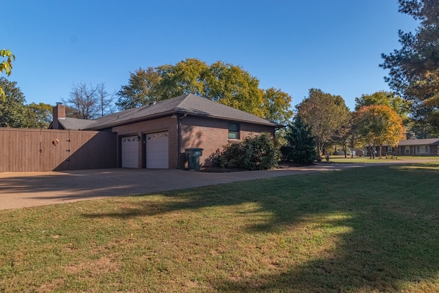 view of side of home with a garage and a lawn