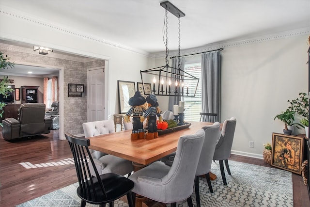 dining space with ornamental molding, hardwood / wood-style floors, and a chandelier