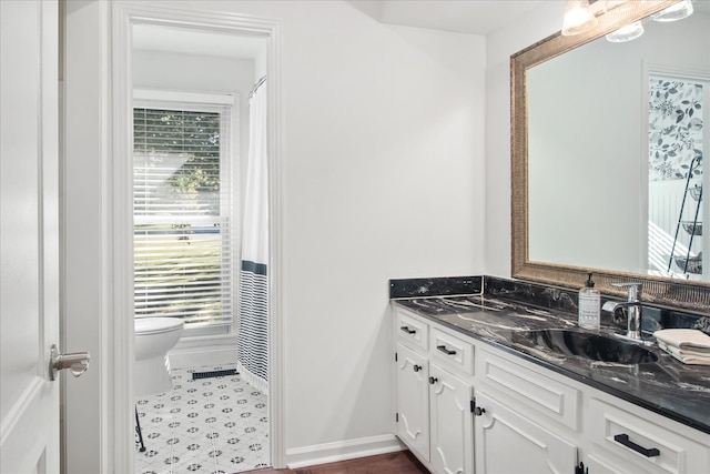 bathroom featuring vanity, toilet, and tile patterned floors