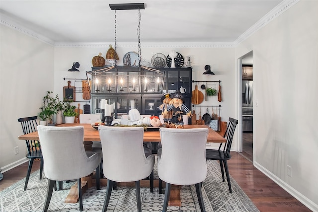 dining space featuring ornamental molding and dark hardwood / wood-style floors