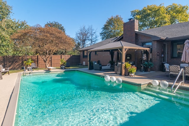 view of pool with a gazebo, a patio area, and a diving board