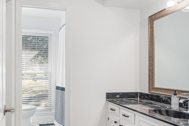 bathroom featuring vanity and toilet