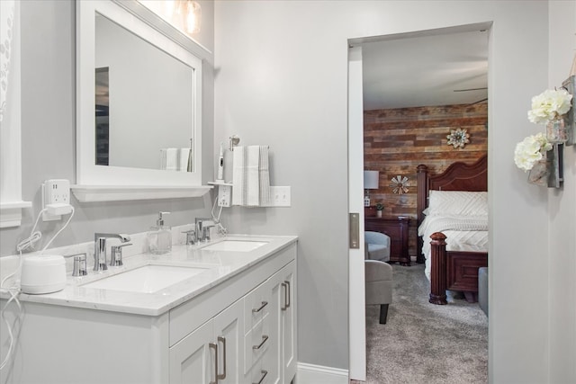 bathroom featuring vanity and wooden walls